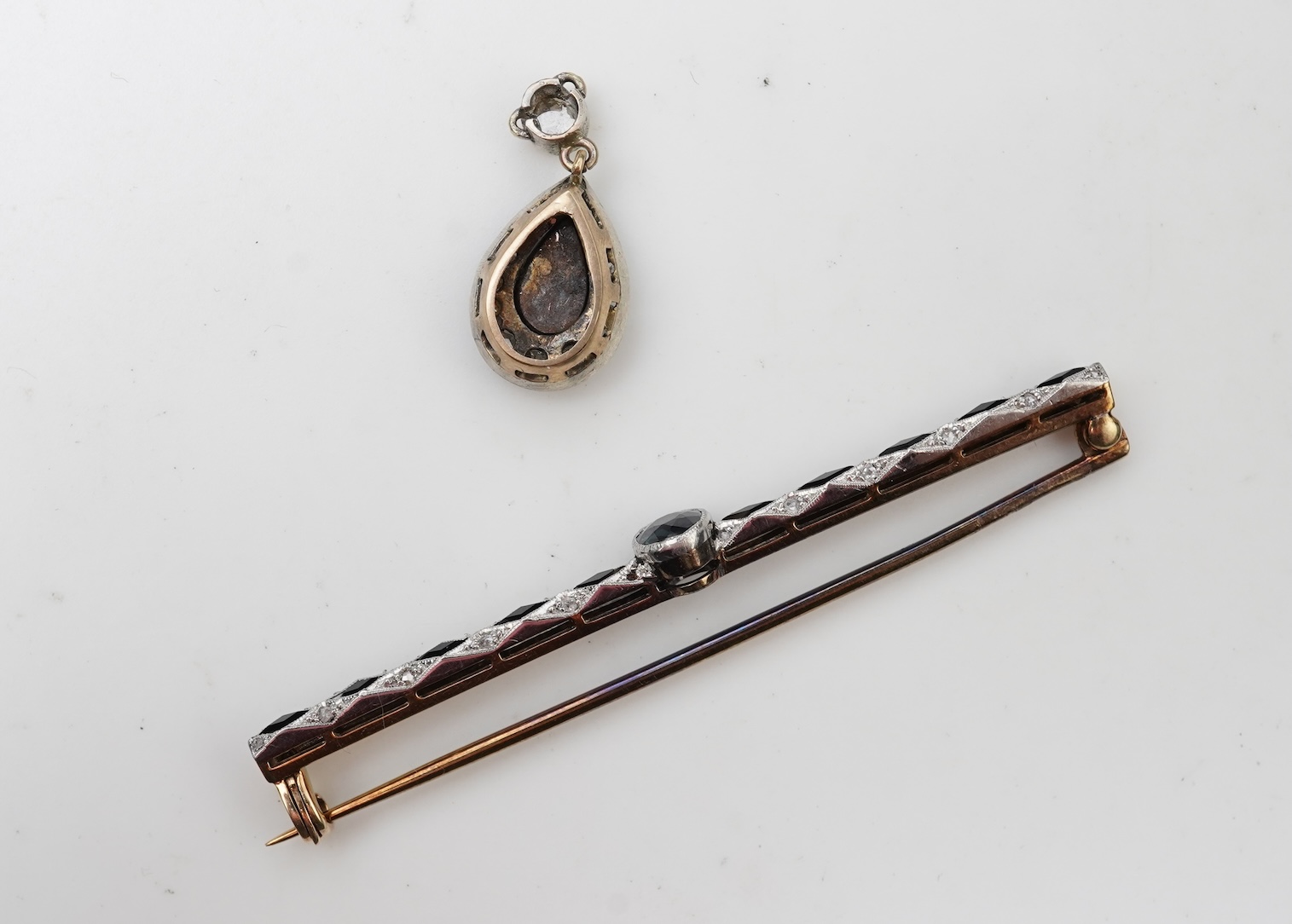 A sapphire bar brooch and an enamel and diamond pendant, early 20th century
